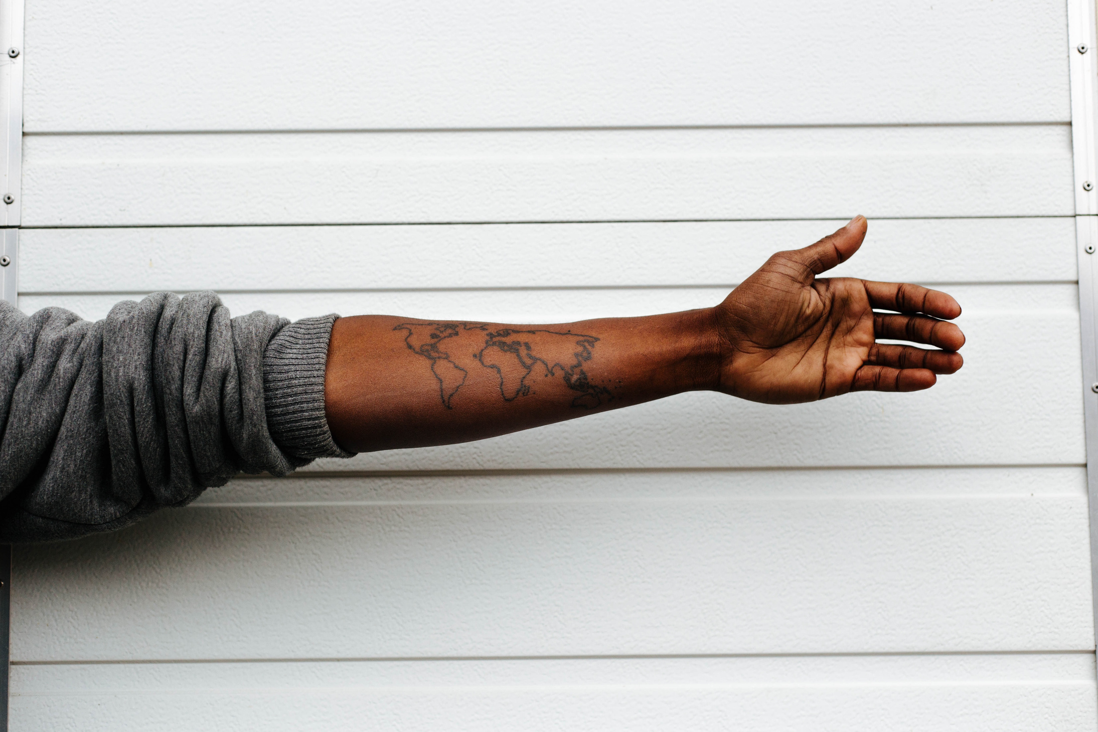 Man Showing Arm Tattoo